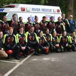 A team of AMR lifeguards pose in front of a river rescue vehicle at Glenn Otto Park in Troutdale.