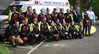 A team of AMR lifeguards pose in front of a river rescue vehicle at Glenn Otto Park in Troutdale.