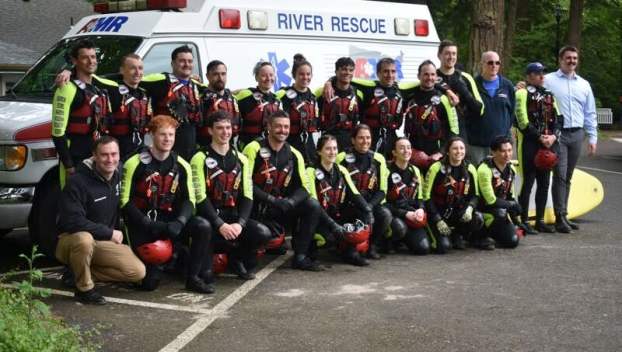 A team of AMR lifeguards pose in front of a river rescue vehicle at Glenn Otto Park in Troutdale.