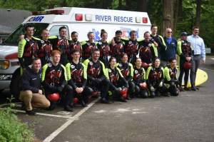 A team of AMR lifeguards pose in front of a river rescue vehicle at Glenn Otto Park in Troutdale.