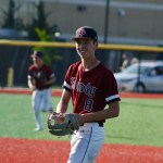 Sandy baseball player Brayden Sievertsen, wearing a red jersey, smiles on the baseball field