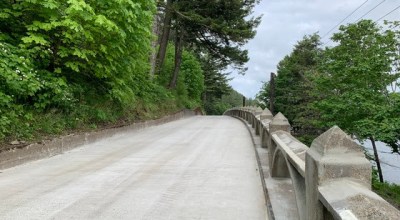 The viaduct on the Historic Highway after repairs/renovations, trees line the side of the roadway